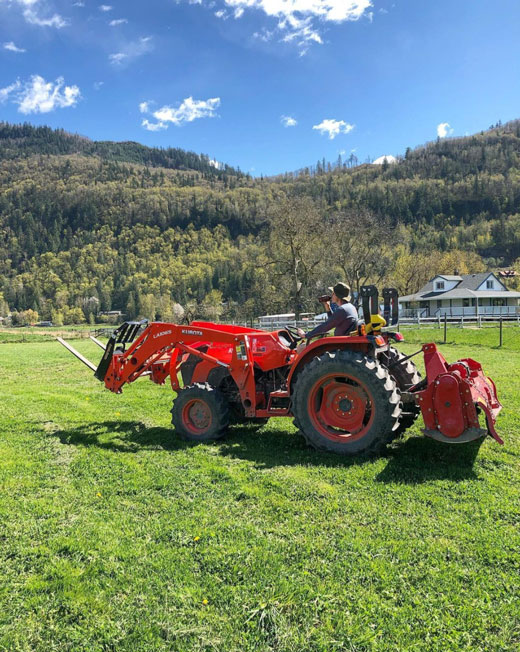 will riding a tractor on the farm