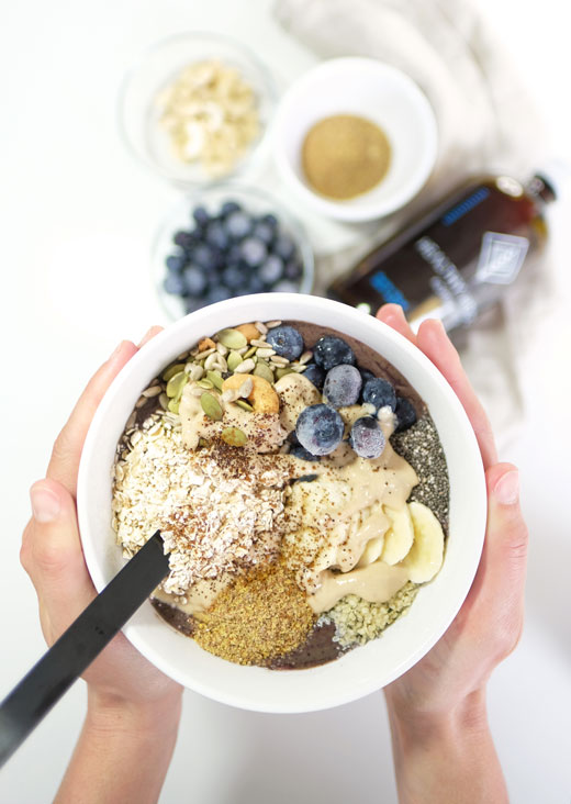 woman holding a smoothie bowl in her hands