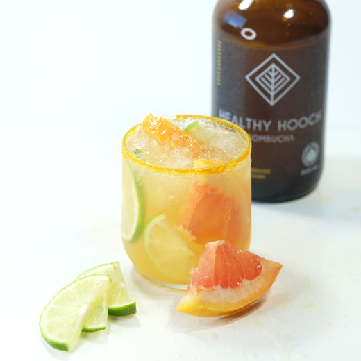 turmeric citrus mocktail with some sliced fruit in front of the glass